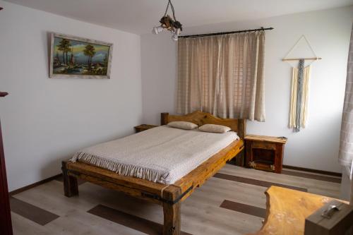 a bedroom with a wooden bed and a window at AMA house in Alba Iulia