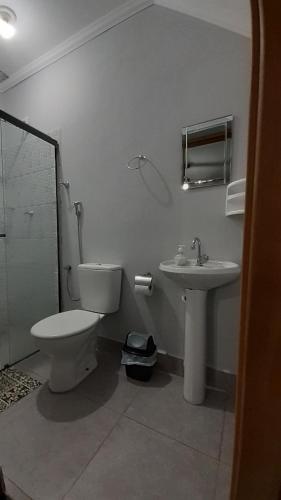 a bathroom with a toilet and a sink at Lodge Hostel Piracicaba in Piracicaba