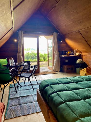 a bedroom with a bed and a table and chairs at The Tin Tent in King's Lynn