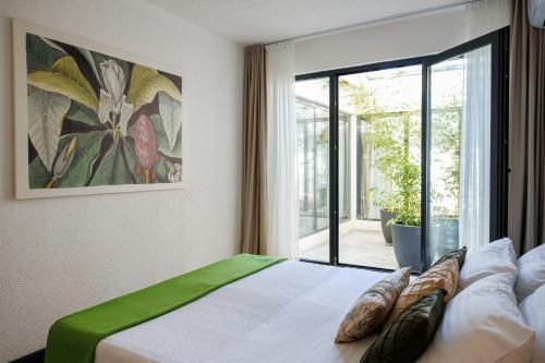 a bedroom with a bed with a large window at Adriatic Masterpiece Residence in Sveti Stefan