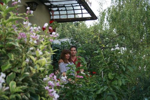 a man and a woman standing in a garden at Base for Adventurers - Urban Guerrilla in Negotin