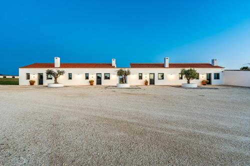 a large building with trees in front of it at Monte da Fonte in Zambujeira do Mar