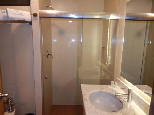a bathroom with a sink and a shower at Hotel El Salvador in Mexico City