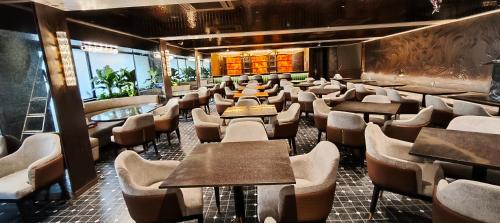 a row of tables and chairs in a restaurant at SILVER INN, Andheri in Mumbai