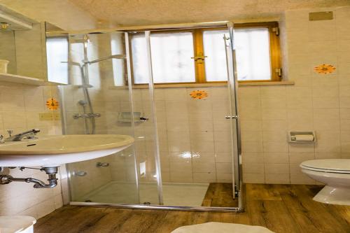 a bathroom with a shower and a sink and a toilet at Holiday Mantovani in Brenzone sul Garda