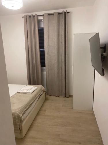 Ένα ή περισσότερα κρεβάτια σε δωμάτιο στο B&B La Fenice