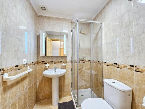 a bathroom with a toilet and a sink and a shower at Piso Romántico con piscina in Formentera de Segura