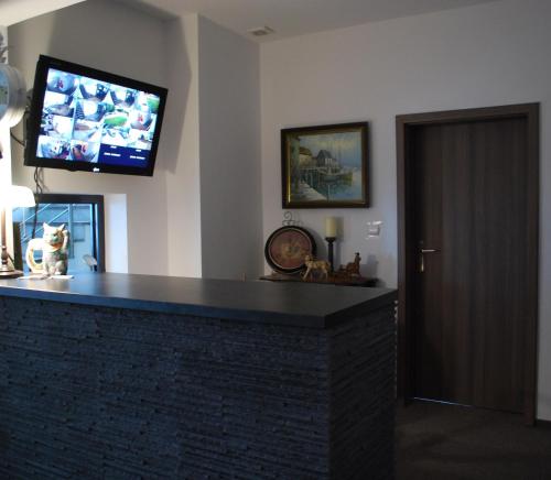a living room with a fireplace with a flat screen tv at Dom Wczasowy Zefir in Świnoujście