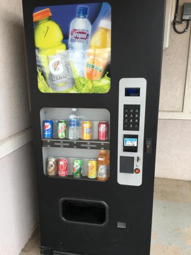 a vending machine filled with drinks and drinks at Budget Inn in Fort Stockton