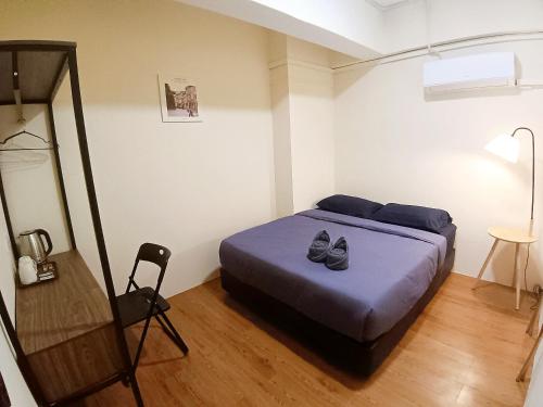 Postel nebo postele na pokoji v ubytování KK Home Warisan Square