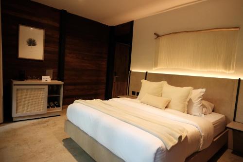 a bedroom with a large bed with white sheets and pillows at Isla Clara Hotel in San Francisco