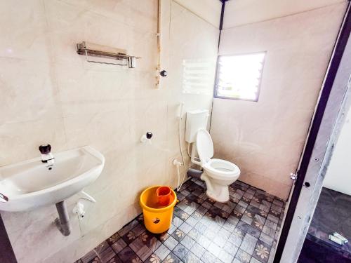 a bathroom with a sink and a toilet at coastal beach front stay in Gokarna