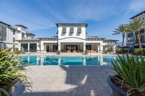 a swimming pool in front of a house at The Edge at Millenia in Orlando