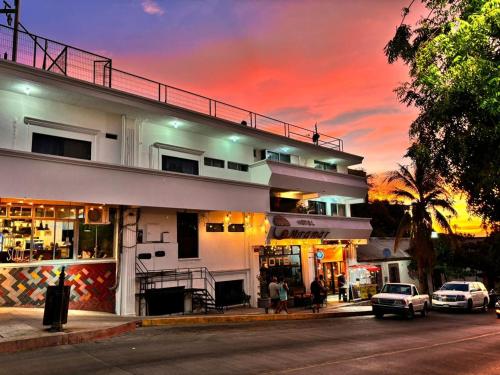 a building with cars parked in front of it at Hotel Miramar - La Paz in La Paz
