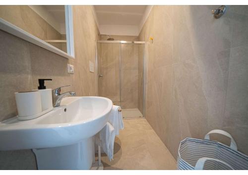 a bathroom with a sink and a shower at Maison Vittoria in Ischia Town