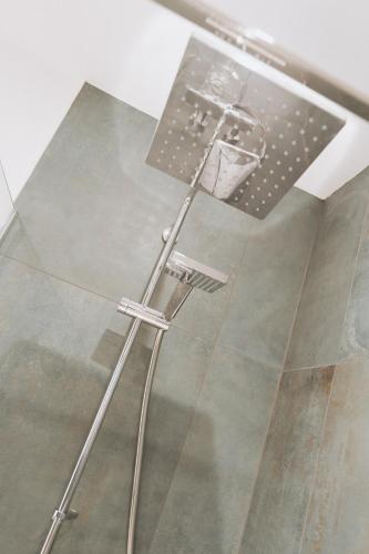 a shower in a room with a glass floor at Marine Cottage 1 - With Private Hot Tub in Newbiggin-by-the-Sea