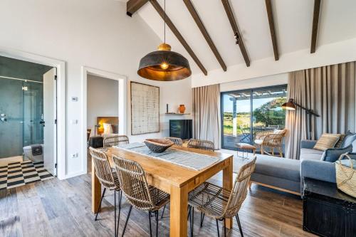 a dining room with a table and chairs at Monte da Fonte in Zambujeira do Mar