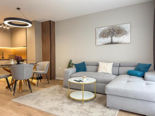 a living room with a couch and a table at 2BР Apartment in a Modern Complex in Plovdiv