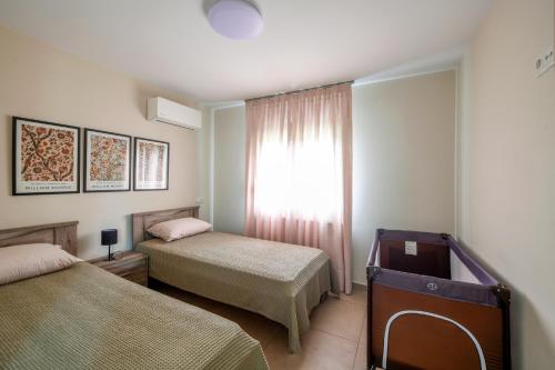 een slaapkamer met twee bedden en een raam bij Villa Natura in Kavala