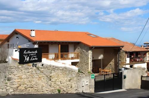 a house with a sign on a stone wall at El Rincón De Cabello in Sierra