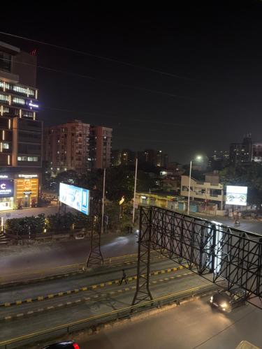 a view of a city at night with billboards at Hotel Royal Inn in Ahmedabad