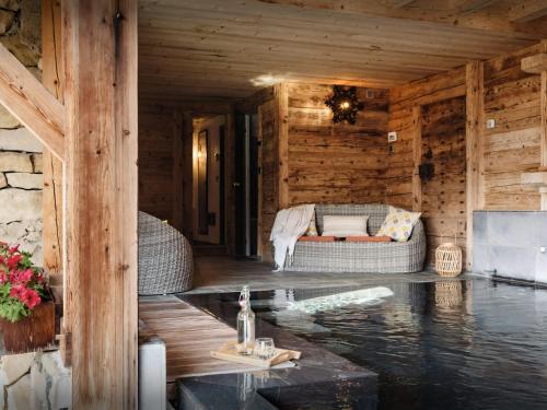 a living room of a log cabin with a couch at Chalet Ladroit - OVO Network in Les Clefs