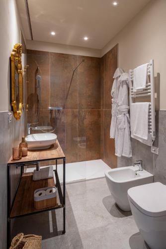 a bathroom with a sink and a toilet and a shower at Casa Margherita Camere & Benessere in Roccaforte Mondovì