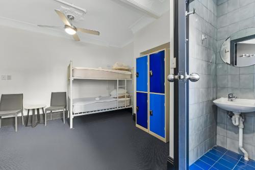 a bathroom with a sink and a toilet and a mirror at London Gate Backpackers Hotel in Sydney