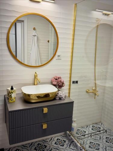a bathroom with a sink and a mirror at Boutique Apartment 2 in Ploieşti