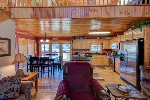 a living room with a couch and a kitchen at New River Ramble in Todd