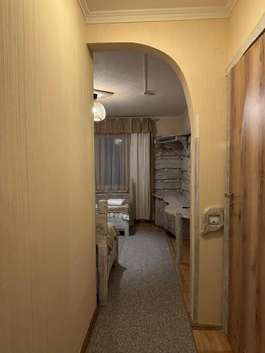 a hallway leading to a room with a bedroom at AQUARIUS Eco Family Hotel in Lviv