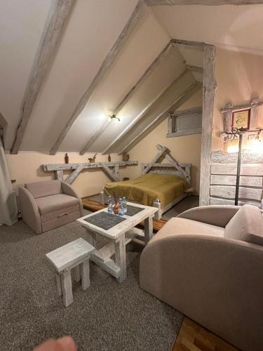 a living room with two couches and a bed at AQUARIUS Eco Family Hotel in Lviv