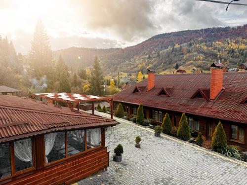 a view of a building with mountains in the background at Chalet Filvarok in Slavske