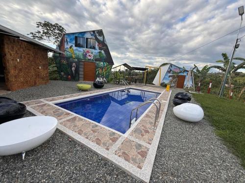 a swimming pool in front of a house at Finca de Descanso El Ocaso in Sevilla