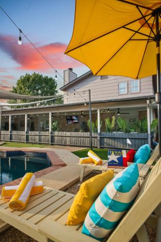 a pool with chairs and an umbrella next to a pool at Great home, great location at a great price! in San Antonio