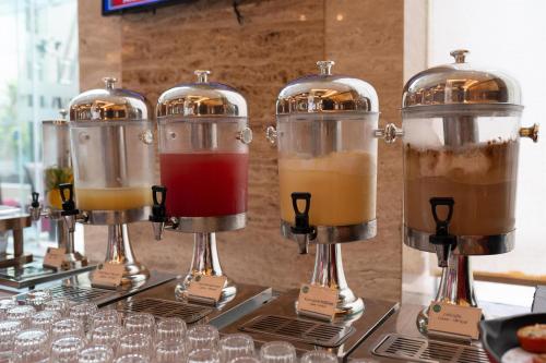 a row of coffee grinders with different types of drinks at Radisson Blu Hotel, Nagpur in Nagpur