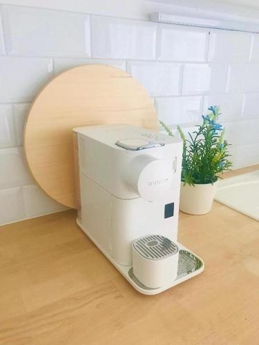 a coffee machine sitting on a counter with a plate at Garden Apartment in Kecskemét