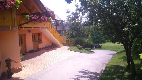 a driveway in front of a house with a building at Apartment Beli Zajec in Mozirje