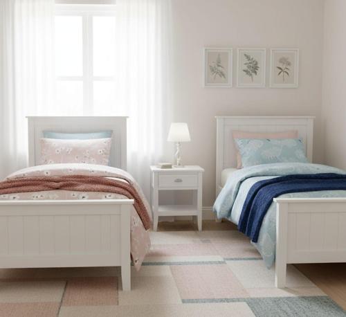 a white bedroom with two beds and a window at swahmaya apartments for rent in Sowayma