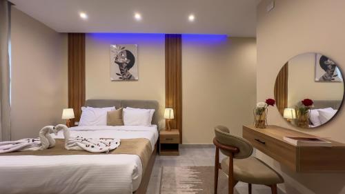 a hotel room with two beds and a mirror at pyramids palace view in Cairo