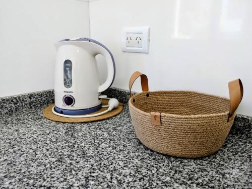 een wit apparaat op een aanrecht naast een mandje bij Casa con jardín Las Marías 1 in Miramar