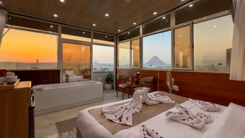 a bedroom with a tub and a bed with towels at pyramids palace view in Cairo