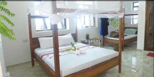 Postel nebo postele na pokoji v ubytování CAAA Youth Hostel