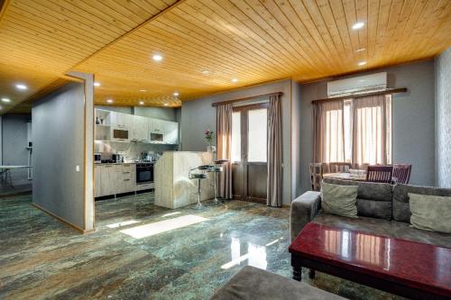 a living room with a couch and a kitchen at Aleqs in Tbilisi City