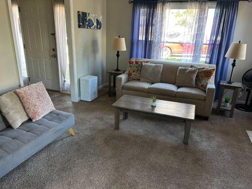 a living room with a couch and a coffee table at The Parkside Townhome in Columbus