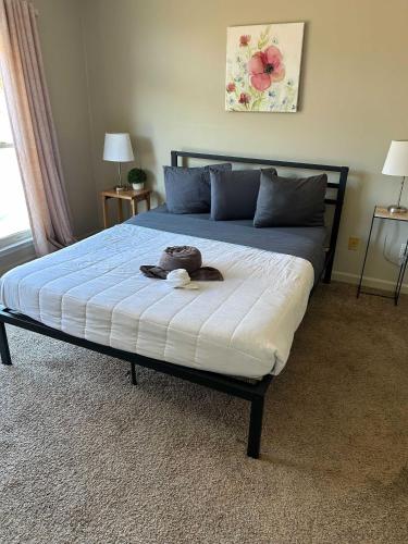 a bed with a stuffed animal sitting on top of it at The Parkside Townhome in Columbus