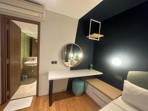 a bathroom with a sink and a mirror on the wall at Vortex suites klcc by Kualalampur vibes in Kuala Lumpur