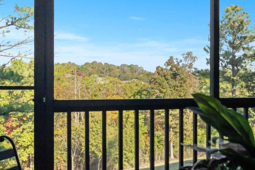 a view from a balcony with a view of the woods at Fairway To Heaven - For 8ppl in Branson West