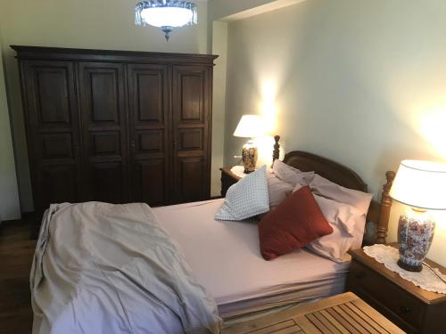 a bedroom with a bed with two lamps on it at Casa Monsenhor in Braga