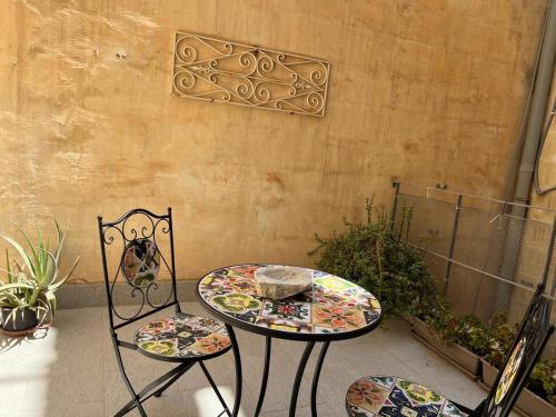 a table and two chairs sitting on a patio at Charming Apartment in the Heart of Valletta in Valletta